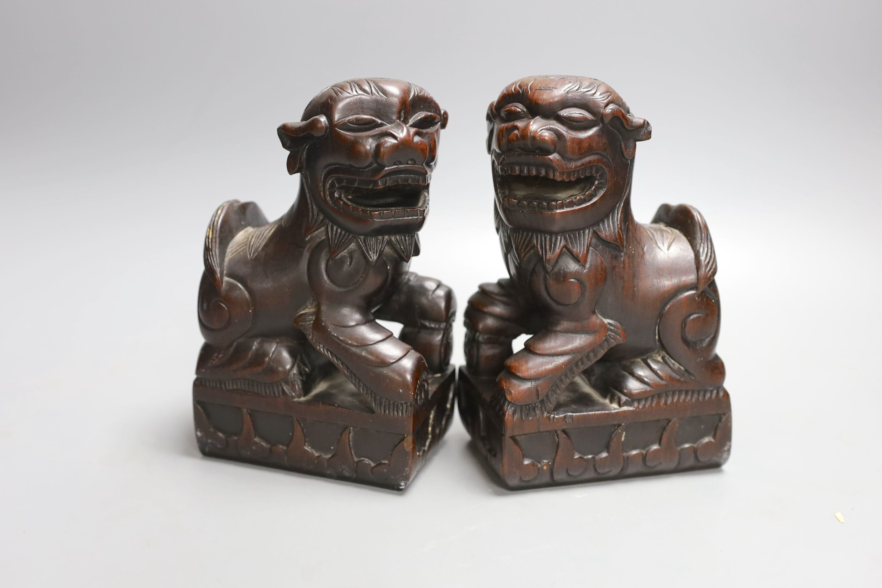 A pair of Chinese hongmu Buddhist lion figures, late 19th century - 18cm high